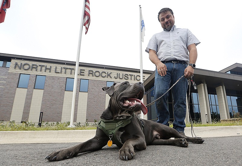 Ezequiel Madrigal stands outside the North Little Rock Justice Center with his cane corso, Smokey, after his court appearance on Thursday.
(Arkansas Democrat-Gazette/Thomas Metthe)