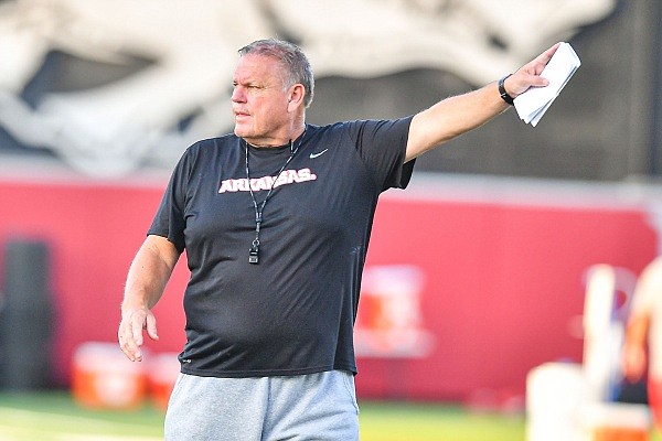 Arkansas head coach Sam Pittman signals to his team, Friday, Aug. 4, 2023, during the Razorbacks’ first practice of fall camp at the Fred W. Smith Football Center in Fayetteville.