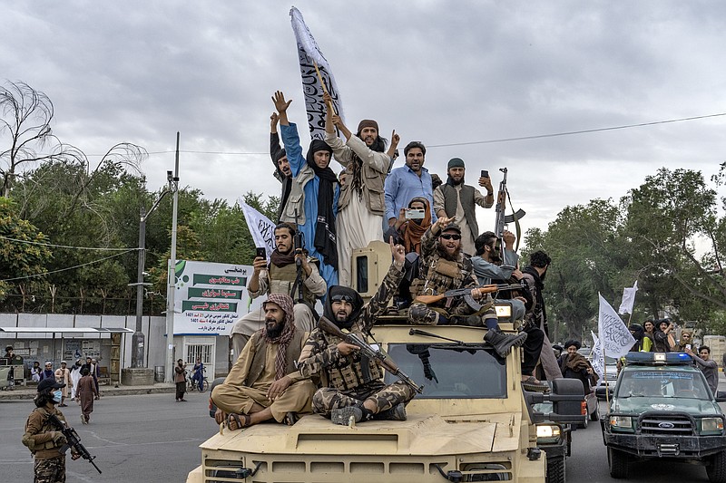 File - Taliban fighters celebrate one year since they seized the Afghan capital, Kabul, in front of the U.S. Embassy in Kabul, Afghanistan, Monday, Aug. 15, 2022. (AP Photo/Ebrahim Noroozi, File)