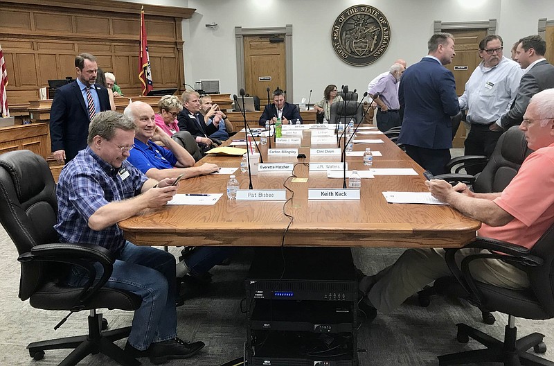 Justices of the peace sit or meet with one another shortly before a Quorum Court meeting at the Saline County Courthouse on Monday, Aug. 21, 2023. (Arkansas Democrat-Gazette/Josh Snyder)