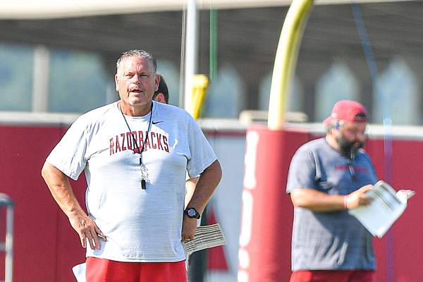 Arkansas head coach Sam Pittman (left) looks on, Friday, Aug. 11, 2023, during practice at the Fred W. Smith Football Center in Fayetteville.