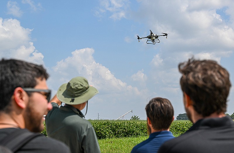 Joel Jones demonstrates his drone equipment on Wednesday at the University of Arkansas Agricultural Park. The University of Arkansas hosted a drone demonstration and talk for students and interested community members about the benefits of using drones in farming. Jones is the president and chief pilot for Drone Crop Services.
(NWA Democrat-Gazette/Caleb Grieger)