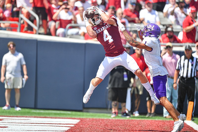 Arkansas wide receiver Isaac TeSlaa (4) catches a touchdown pass over Western Carolina safety Mateo Sudipo (1), Saturday, Sept, 2, 2023, during the first quarter at War Memorial Stadium in Little Rock. Visit nwaonline.com/photo for today's photo gallery..(NWA Democrat-Gazette/Hank Layton)