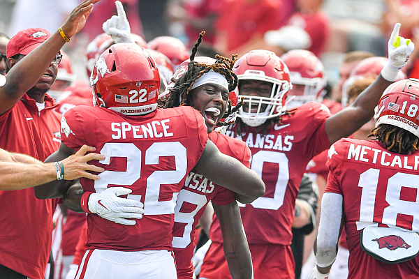 Arkansas linebacker Brad Spence (22) celebrates with wide receiver Davion Dozier (88) after returning an interception for a touchdown, Saturday, Sept. 2, 2023, during the fourth quarter of the Razorbacks’ 56-13 win over Western Carolina at War Memorial Stadium in Little Rock.