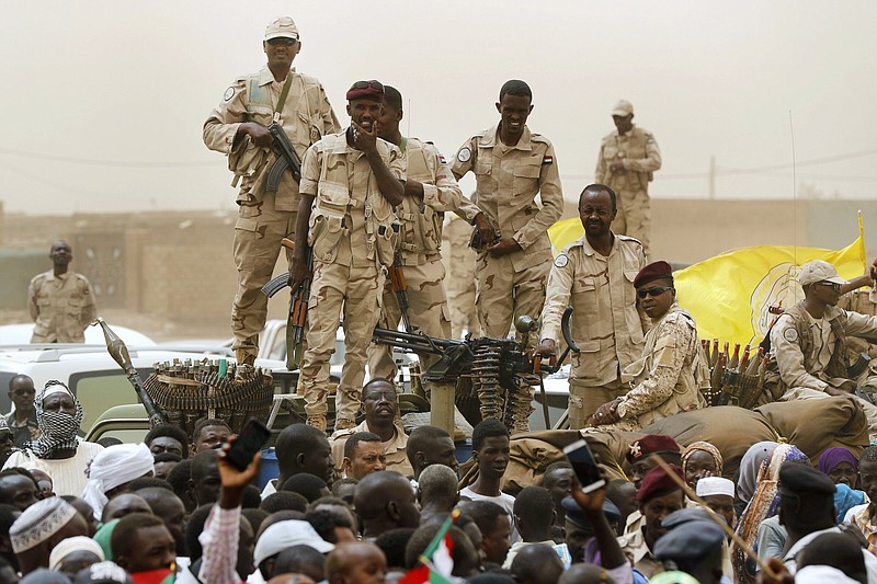 Sudanese soldiers from the Rapid Support Forces unit stand on their vehicle during a military-backed rally June 2019, in Mayo district, south of Khartoum, Sudan.
(AP/Hussein Malla)