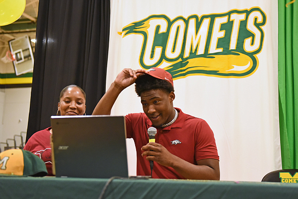 Charleston Collins is joined by his mother, Whitney Bradley, while announcing his commitment to the University of Arkansas on Friday, April 21, 2023, at the Wilbur D. Mills High School gymnasium.