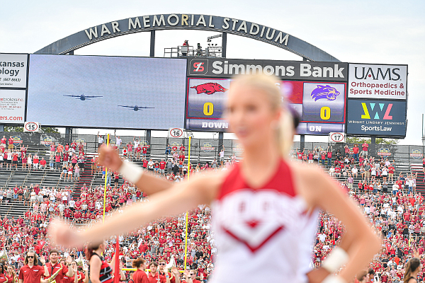 Arkansas cheerleaders perform during a military flyover, Saturday, Sept. 2, 2023, before the first quarter of the Razorbacks’ 56-13 win over Western Carolina at War Memorial Stadium in Little Rock.