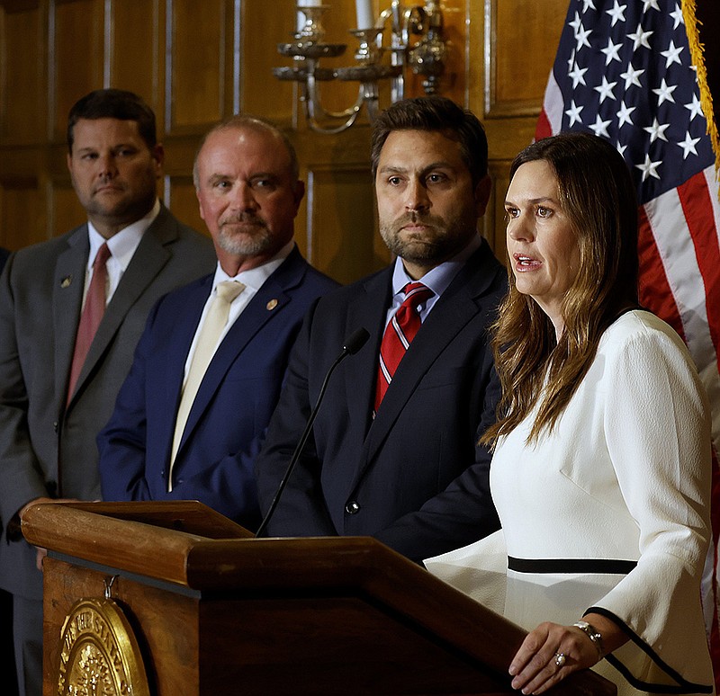 Gov. Sarah Huckabee Sanders (from right) announces the calling of a special legislative session as Jonathan Dismang, R-Beebe; Rep. Les D. Eaves, R-Searcy; and Sen. Bart Hester, R-Cave Springs look on Friday at the state Capitol in Little Rock.
(Arkansas Democrat-Gazette/Thomas Metthe)