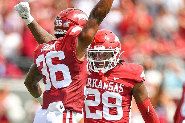 Arkansas linebackers Jaheim Thomas (28) and Jordan Crook (36) react after a play, Saturday, Sept, 2, 2023, during the first quarter of the Razorbacks’ 56-13 win over Western Carolina at War Memorial Stadium in Little Rock. Visit nwaonline.com/photo for the photo gallery.