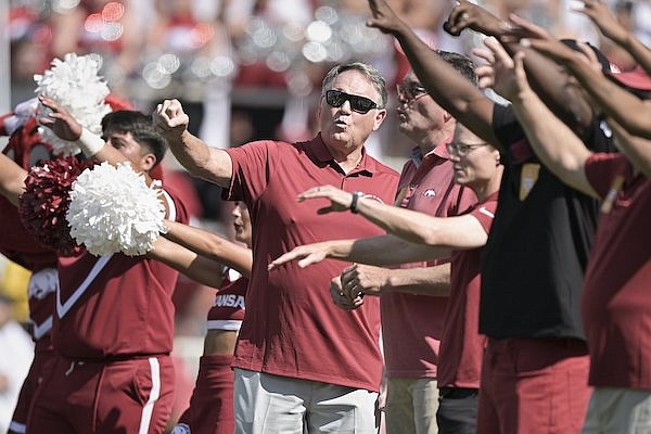 Former Arkansas football coach Houston Nutt calls the Hogs with other members of the 2023 UA Sports Hall of Honor class during a game against Kent State on Saturday, Sept. 9, 2023, in Fayetteville.