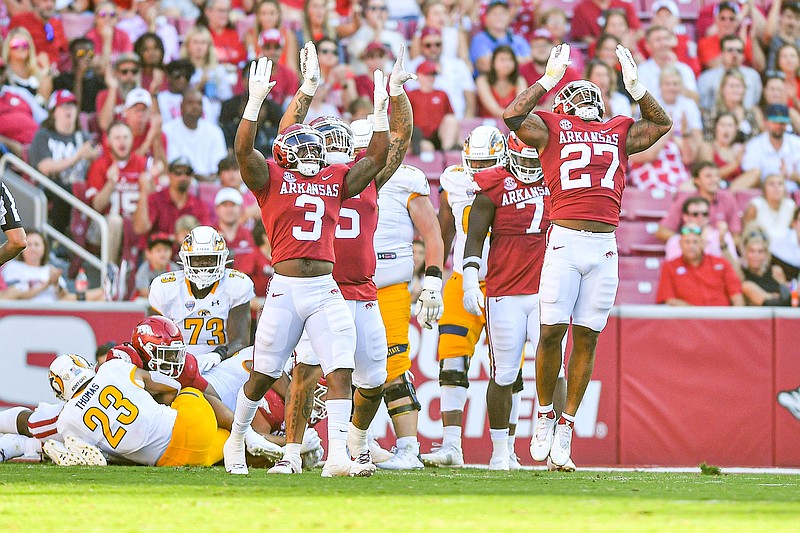 Arkansas linebacker Chris Paul Jr. (27), linebacker Antonio Grier (3) and defensive lineman Cameron Ball (5) celebrate after stopping Kent State on third-and-goal, Saturday, Sept, 9, 2023, during the fourth quarter of the RazorbacksÕ 28-6 win over the Golden Flashes at Donald W. Reynolds Razorback Stadium in Fayetteville. Visit nwaonline.com/photo for today's photo gallery..(NWA Democrat-Gazette/Hank Layton)