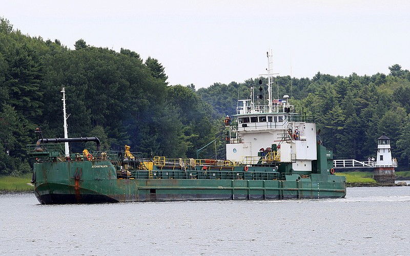 FILE - Spectators watch as a dredger works to deepen a shallow channel in the Kennebec River, upstream from the Doubling Point Lighthouse, Aug. 5, 2011, (AP/Robert F. Bukaty, file)