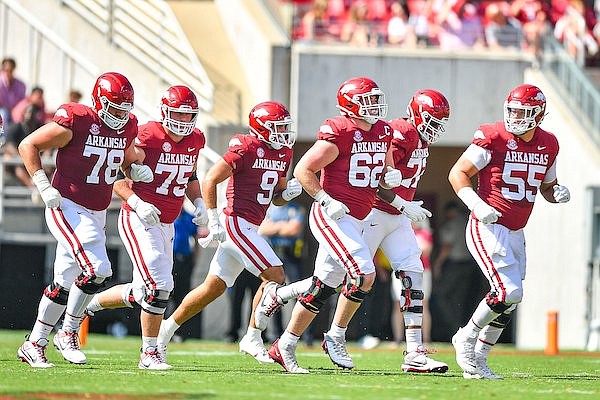 Arkansas offensive linemen Joshua Braun (78), Patrick Kutas (75), Brady Latham (62), Andrew Chamblee (72) and Beaux Limmer (55) take the field with tight end Luke Hasz (9) on Saturday, Sept. 9, 2023, during the first quarter of the Razorbacks’ 28-6 win over Kent State at Reynolds Razorback Stadium in Fayetteville.