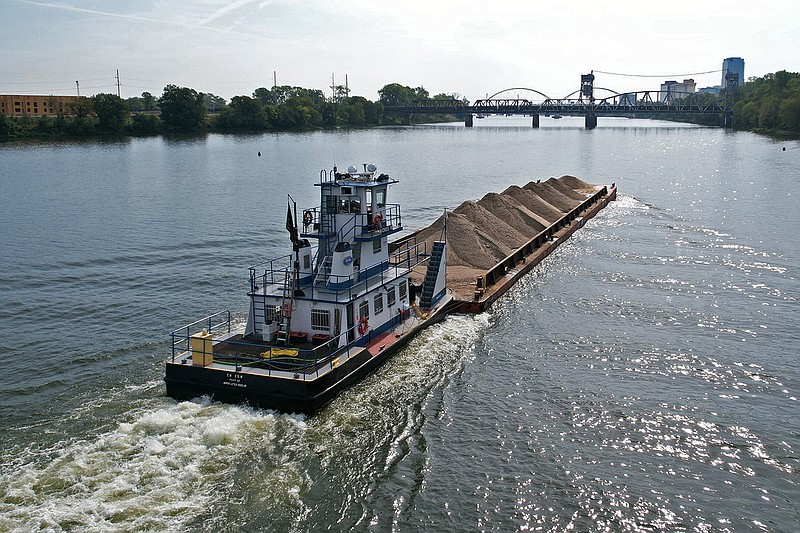 A barge carrying a load of cargo heads toward downtown Little Rock along the Arkansas River on Monday, Sept. 11, 2023. (Arkansas Democrat-Gazette/Colin Murphey)