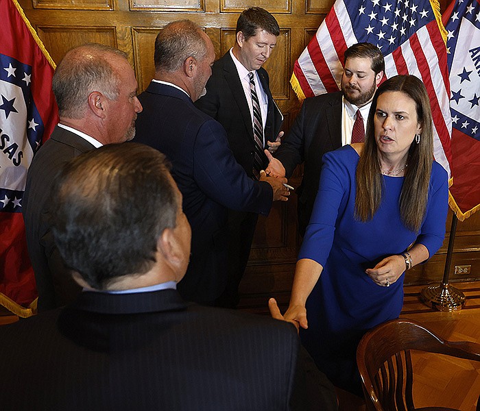 Gov. Sarah Huckabee Sanders shakes hands with state Rep. Howard Beaty, R-Crossett, and other lawmakers at the state Capitol in Little Rock on Thursday after signing bills passed during the special legislative session. More photos at arkansasonline.com/915session/.
(Arkansas Democrat-Gazette/Thomas Metthe)