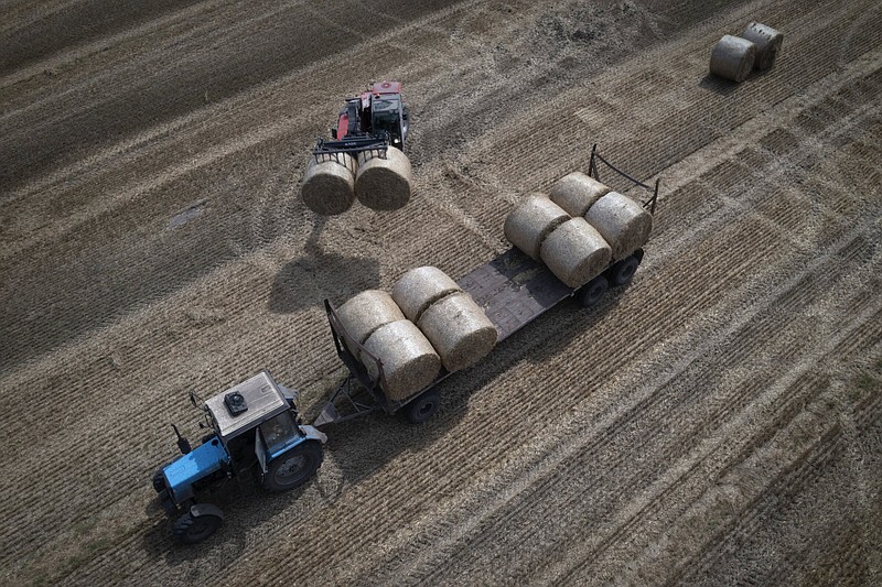 A tractor collects straw in a field on a private farm in Zhurivka, Kyiv region, Ukraine, in August.
(AP/Efrem Lukatsky)
