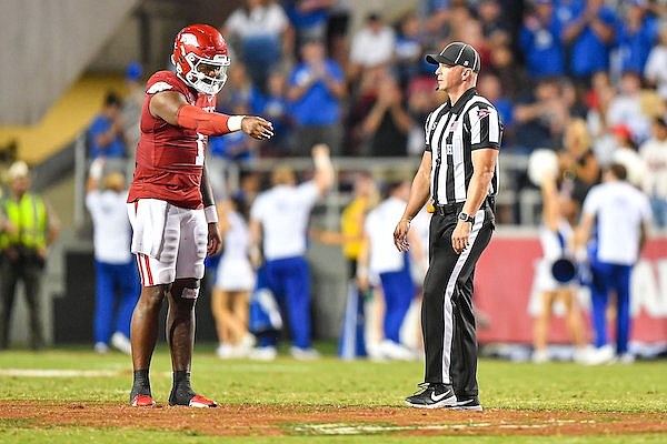 Arkansas quarterback KJ Jefferson (left) talks with an official during a game against BYU on Saturday, Sept. 16, 2023, in Fayetteville.