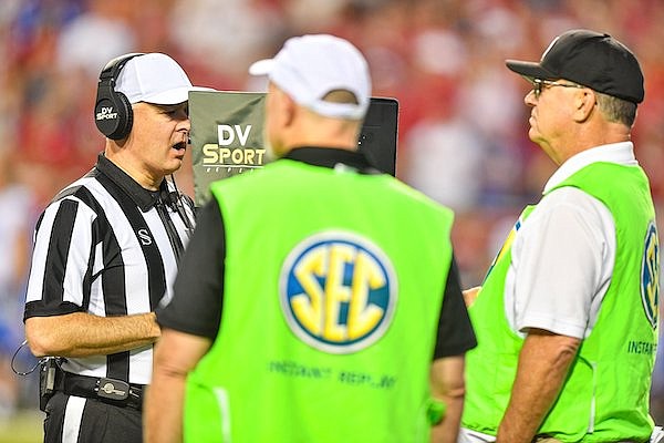 Big 12 referee Kevin Boitmann watches a replay monitor during a game between Arkansas and BYU on Saturday, Sept. 16, 2023, in Fayetteville.