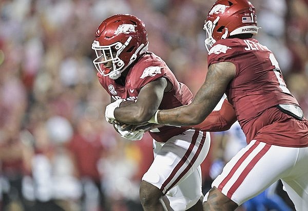 Arkansas running back Rashod Dubinion takes a handoff from quarterback KJ Jefferson during the third quarter of a game against BYU on Saturday, Sept. 16, 2023, in Fayetteville.