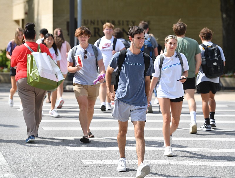 University of Arkansas, Fayetteville students cross Maple Street at Garland Avenue on the university campus in this Aug. 22, 2022 file photo. (NWA Democrat-Gazette/Andy Shupe)