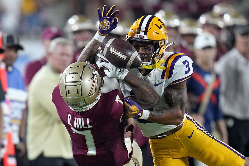 LSU safety Greg Brooks Jr. (3) breaks up a pass intended for Florida State wide receiver Destyn Hill, left, during the first half of an NCAA college football game Sunday, Sept. 3, 2023, in Orlando, Fla. (AP Photo/John Raoux)