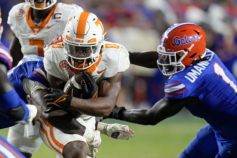 Tennessee running back Jaylen Wright, center, is stopped by Florida linebacker Scooby Williams, left, and defensive end Princely Umanmielen (1) during the second half of an NCAA college football game, Saturday, Sept. 16, 2023, in Gainesville, Fla. (AP Photo/John Raoux)