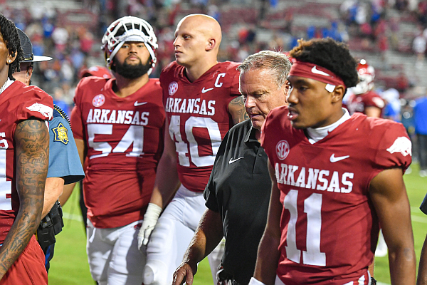 Arkansas head coach Sam Pittman (second from right) walks off the field with his team, Saturday, Sept. 16, 2023, following the BYU Cougars’ 38-31 win over the Razorbacks at Donald W. Reynolds Razorback Stadium in Fayetteville.