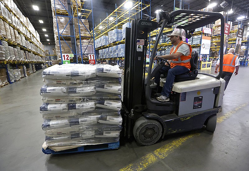 Warehouse manager Kyle Thomas unloads a pallet of rice that was donated Wednesday to the Arkansas Food Bank in Little Rock honoring National Rice Month. The Arkansas Rice Federation donated 240,000 pounds of rice to be distributed across the state. The rice will provide 1.8 million servings of rice to feed families, children and seniors, according to the Rice Federation.
(Arkansas Democrat-Gazette/Thomas Metthe)