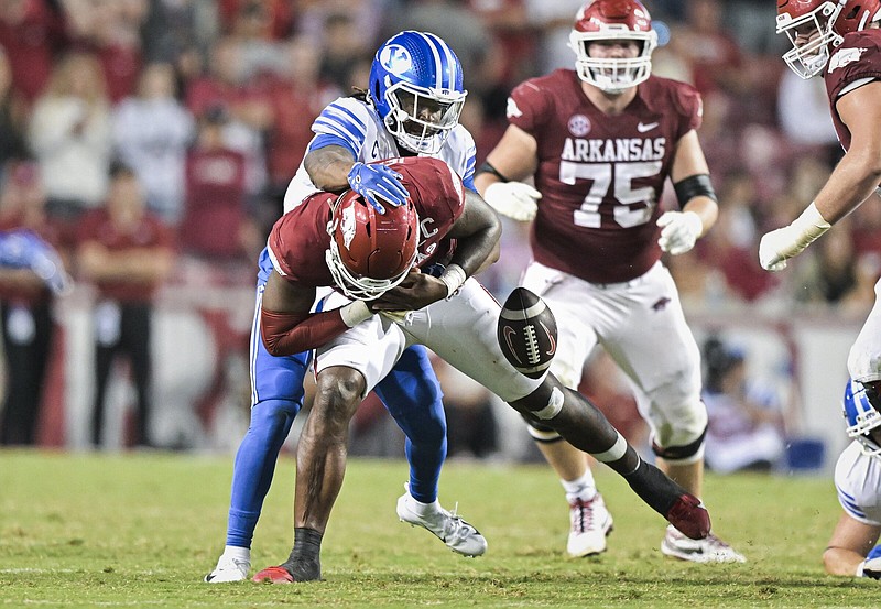Arkansas quarterback KJ Jefferson (center) is sacked by BYU cornerback Eddie Heckard, forcing a fumble and a turnover during the fourth quarter Saturday at Reynolds Razorback Stadium in Fayetteville. The Razorbacks travel to Baton Rouge on Saturday to face No. 12 LSU.
(NWA Democrat-Gazette/Charlie Kaijo)