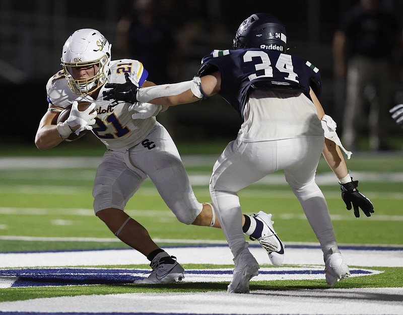 Shiloh Christian running back Bo Williams (left) slips past Little Rock Christian defensive lineman Jaxon Carleson during their Sept. 1 game in Little Rock. After three games, Williams is nearly a third of the way toward reaching his goal of having 2,000 yards rushing for the season.
(Arkansas Democrat-Gazette/Thomas Metthe)