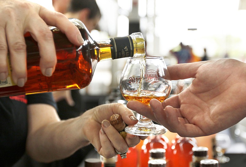 Staff file photo / A volunteer pours Yellow Rose whiskey during the Tennessee Whiskey Festival at the First Tennessee Pavilion on May 20, 2017. Tennessee Whiskey Festival returns this year from 1-5 p.m. Saturday at First Horizon Pavilion.