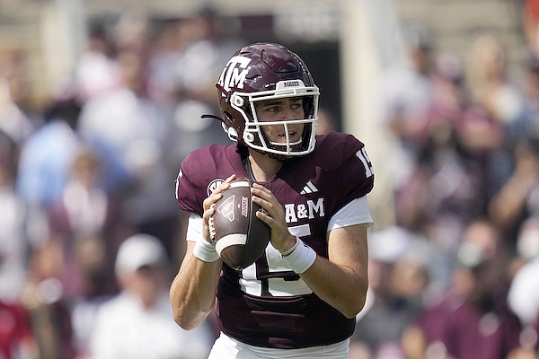 Texas A&M quarterback Conner Weigman (15) looks to pass downfield against Auburn during the first quarter of an NCAA college football game Saturday, Sept. 23, 2023, in College Station, Texas. (AP Photo/Sam Craft)