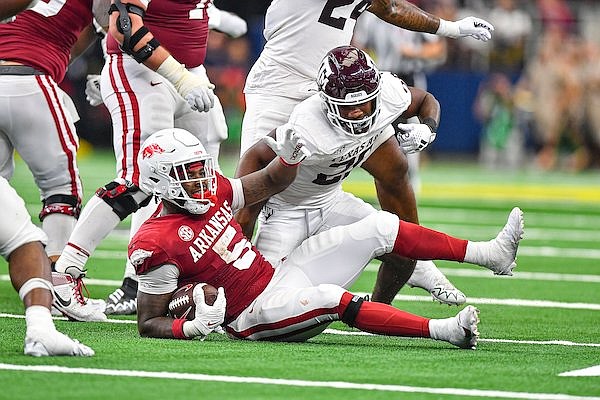 Arkansas running back Raheim Sanders (5) reacts near Texas A&M defensive back Josh DeBerry (28) after being stopped short on fourth down, Saturday, Sept, 30. 2023, during during the second quarter of the Southwest Classic at AT&T Stadium in Arlington, Texas.