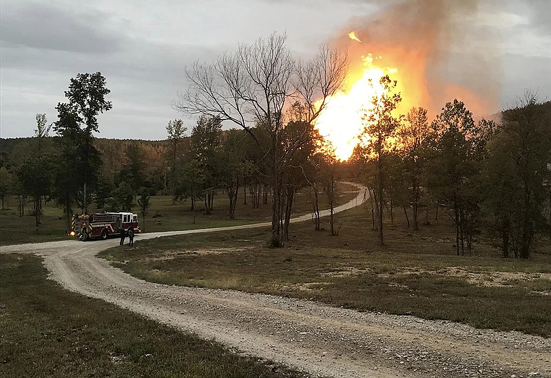 Firefighters watch flames rise from a ruptured pipeline in the Arkansas 298 area near Jessieville on Wednesday. Video online at arkansasonline.com/105jessievillegasline/
(Special to the Democrat-Gazette/Garland County Sheriff’s Office)