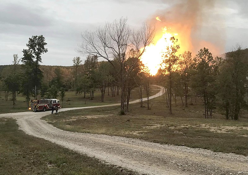 Firefighters watch flames rise from a ruptured pipeline in the Highway 298 area near Jessieville on Wednesday. (Courtesy of the Garland County Sheriff's Office)