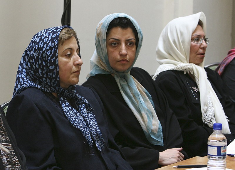 FILE - Prominent Iranian human rights activist Narges Mohammadi, center, sits next to Iranian Nobel Peace Prize laureate Shirin Ebadi, left, while attending a meeting on women's rights in Tehran, Iran, on Aug. 27, 2007. The Nobel Peace Prize has been awarded to Narges Mohammadi for fighting oppression of women in Iran. The chair of the Norwegian Nobel Committee announced the prize Friday, Oct. 6, 2023 in Oslo. (AP Photo/Vahid Salemi, File)
