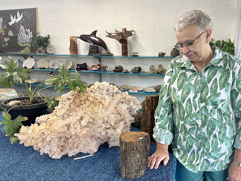 Cathy Fecho looks at a large quartz crystal specimen for sale at her Fiddler’s Ridge Rock Shop outside of Mount Ida. Her son owns Twin Creek Crystal Mine where it was found.
(Arkansas Democrat-Gazette/Aaron Gettinger)