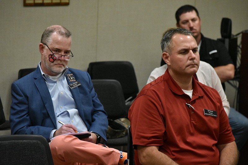 Tim Atkinson (left), principal of Moody Elementary, and Jeff Glover, Hardin Elementary principal, listen to comments during a White Hall School District board meeting Tuesday, Oct. 10, 2023. (Pine Bluff Commercial/I.C. Murrell)