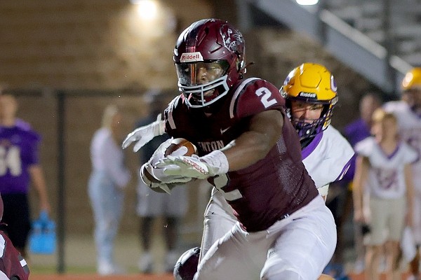 Benton's Braylen Russell runs over Catholic's Caden McConnell on his way to scoring Benton's winning TD during their game Friday Sept. 15, 2023 in Benton.