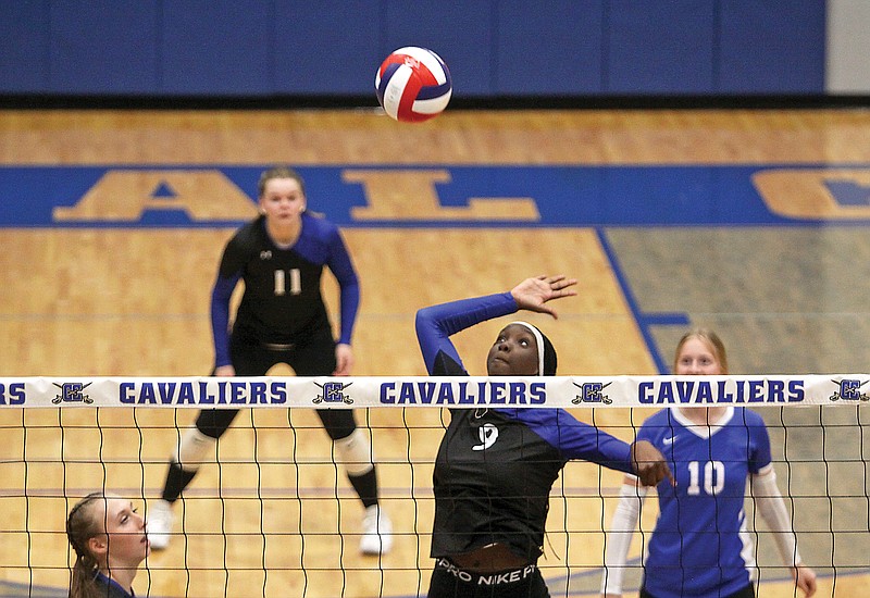 Capital City middle hitter Jada Anderson watches the ball before she spikes it during Thursday night’s match against Eugene at Capital City High School. (Greg Jackson/News Tribune)