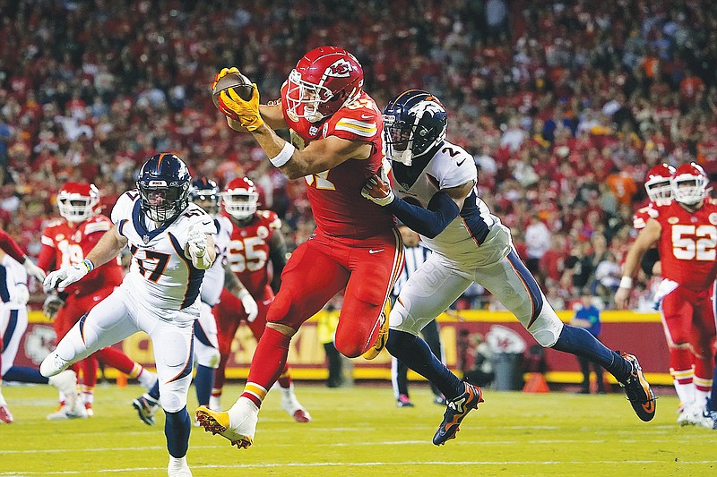 Chiefs tight end Travis Kelce makes a catch Pat Surtain of the Broncos during the first half of Thursday night’s game at Arrowhead Stadium in Kansas City. (Associated Press)