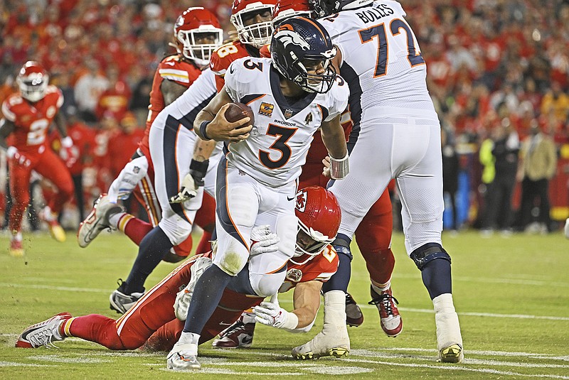 Chiefs linebacker Drue Tranquill tackles Broncos quarterback Russell Wilson for a loss during the second half of Thursday night's game at Arrowhead Stadium in Kansas City. (Associated Press)