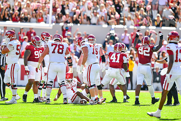 Arkansas quarterback KJ Jefferson (1) is helped up by teammates after getting sacked by Alabama defensive lineman Justin Eboigbe (92), Saturday, Oct. 14, 2023, during the fourth quarter of the Razorbacks’ 24-21 loss to the Crimson Tide at Bryant-Denny Stadium in Tuscaloosa, Ala.