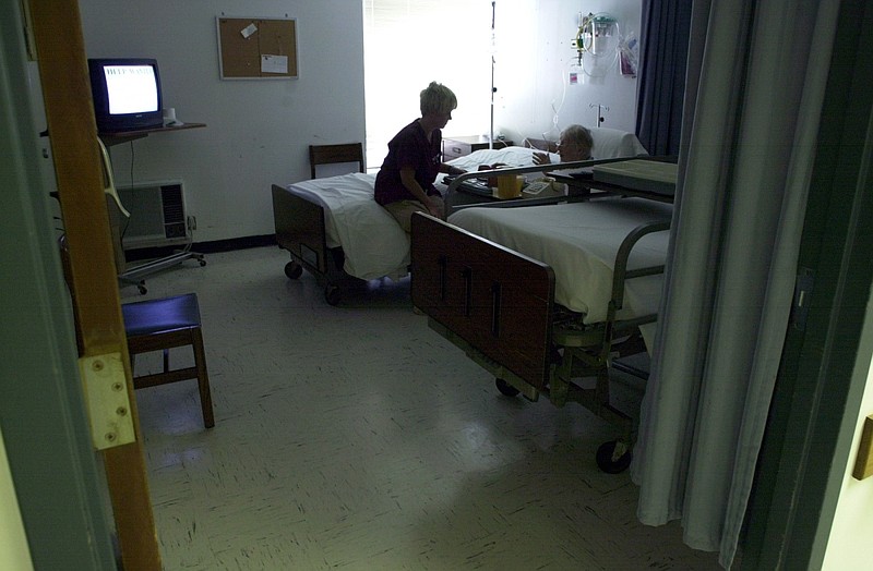 A nurse talks with an elderly patient at Fulton County Hospital in Salem in this August 2002 file photo. The hospital was one of four in Arkansas targeted in 2023 for a share of $16.3 million in emergency assistance from American Rescue Plan funds. (Arkansas Democrat-Gazette file photo)