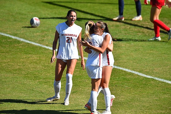 Arkansas soccer players Sophia Aragon (right) and Anna Podojil celebrate a goal as Ava Tankersley (21) looks on during a game against Ole Miss on Sunday, Oct. 22, 2023, in Fayetteville. (Gunnar Rathbun/Arkansas Athletics)
