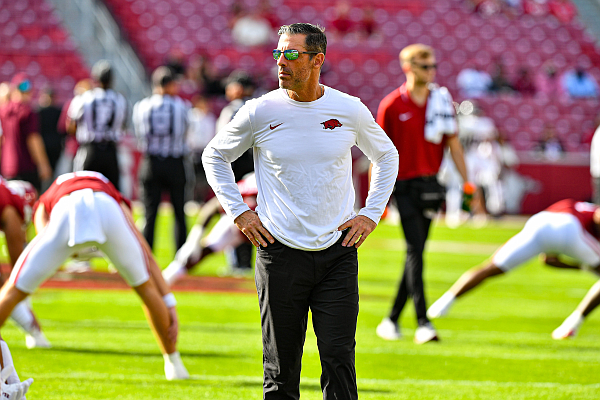 Arkansas offensive coordinator Dan Enos observes warmups, Saturday, Oct. 21, 2023, before a game against Mississippi State at Donald W. Reynolds Razorback Stadium in Fayetteville.