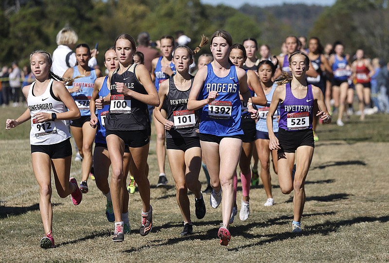 Bentonville’s Haley Loewe (100) leads the pack Thursday after the first mile of the Class 6A girls cross country state championship at Oaklawn Racing Casino Resort in Hot Springs. Loewe won the event with a time of 17 minutes, 49.77 seconds and teammate Devyn O’Daniel was second with a time of 18:34.38.
(Arkansas Democrat-Gazette/Thomas Metthe)