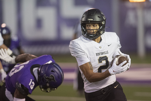 Bentonville’s C.J. Brown runs the ball against Fayetteville, Friday, Oct. 13, 2023, at Harmon Field in Fayetteville.