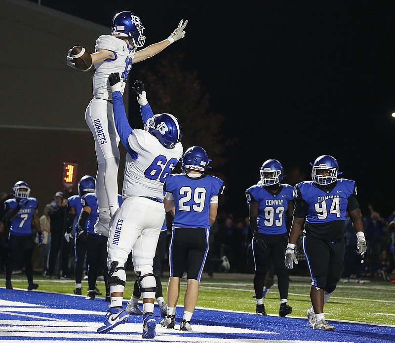 Bryant wide receiver Karter Ratliff (12) celebrates with teammate Cairo Terry (66) after a touchdown during the second quarter of Bryant’s 52-33 win on Friday, Nov. 3, 2023, at John McConnell Stadium in Conway. .(Arkansas Democrat-Gazette/Thomas Metthe)