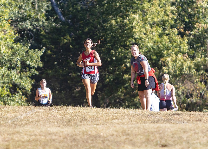 Calvary Lutheran's Mahaila Brunner sprints to the finish line during this season’s Calvary Lutheran Cross Country Invitational at Binder Park. (News Tribune file photo)
